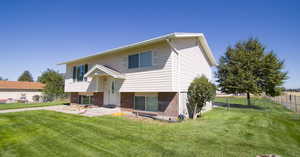 Exterior space featuring a patio and a front lawn