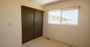 Unfurnished bedroom with a closet and carpet flooring