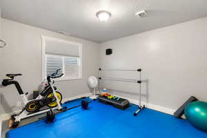 Workout area with a textured ceiling