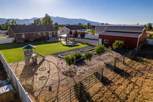 Back of property with a gazebo, a mountain view, and a yard