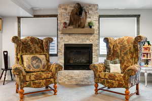 Living area featuring carpet floors and a fireplace