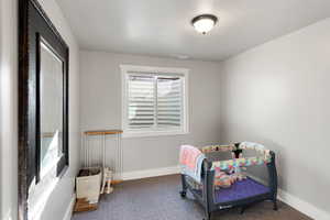 Bedroom featuring a textured ceiling and carpet flooring