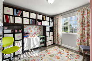 Bedroom with a textured ceiling and wood-type flooring