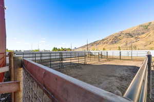 View of yard with a rural view and a mountain view