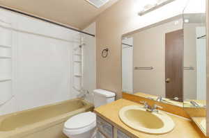 Full bathroom with toilet, shower / bathing tub combination, and vanity.