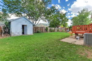 View of yard with a patio area, a shed with power and cooling unit shed has been recently painted