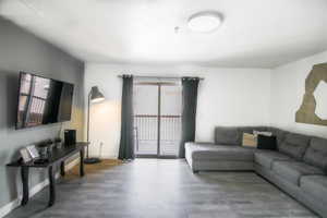 Living room with a wealth of natural light and hardwood / wood-style floors