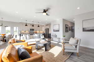 Living room featuring light hardwood / wood-style flooring, sink, and ceiling fan