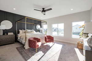 Bedroom with multiple windows, light colored carpet, and ceiling fan