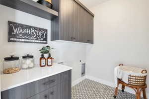 Washroom featuring cabinets and electric dryer hookup