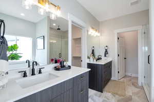 Bathroom featuring vanity and a shower with shower door