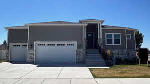 View of front of home featuring a garage and a front yard