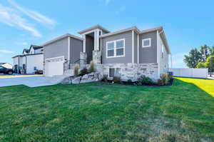 View of front of home with a garage and a front yard