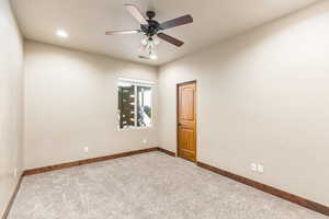 Unfurnished room with carpet floors and ceiling fan