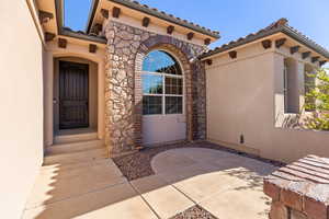 Doorway to property featuring a patio area