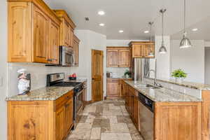 Kitchen featuring light tile patterned floors, appliances with stainless steel finishes, sink, and backsplash