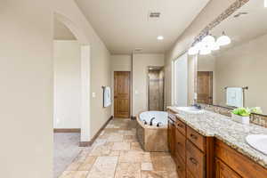 Bathroom featuring tile patterned flooring, independent shower and bath, and vanity