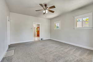 Unfurnished living room leading to kitchen and bedrooms