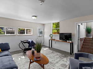 Staged family room with stairs leading to kitchen