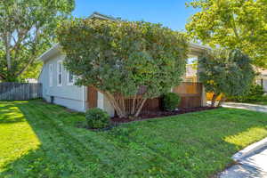 View of side of home featuring a yard