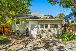 Back of house with a patio area and entrance to family room