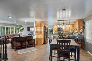 Tiled dining area with a textured ceiling and sink