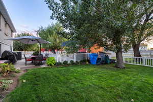 Yard at dusk featuring a patio area