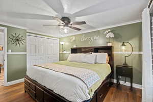 Master Bedroom featuring a closet, ceiling fan, dark hardwood / wood-style flooring, and ornamental molding