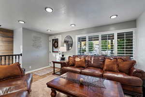 Tiled living room with wood walls and a textured ceiling