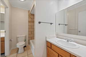 Bathroom with tile patterned flooring, toilet, a textured ceiling, and vanity