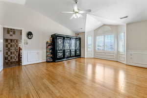 Family room featuring ceiling fan, high vaulted ceiling, and light hardwood / wood-style floors