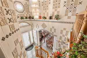 Interior space with tile patterned flooring and a chandelier