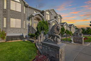 Property exterior at dusk with a yard