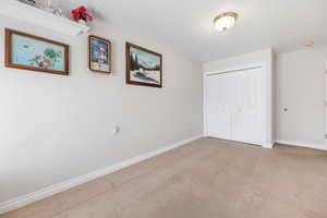 Unfurnished bedroom featuring light carpet