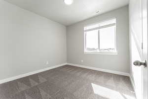 Carpeted empty room with a textured ceiling