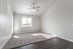 Empty room featuring hardwood / wood-style flooring, ceiling fan, and a textured ceiling