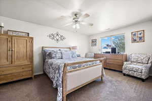 Bedroom featuring ceiling fan, a textured ceiling, and carpet flooring