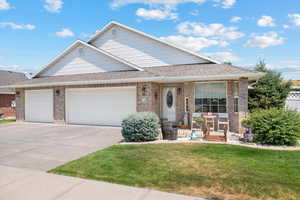 View of front of property featuring a garage and a front yard