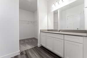 Bathroom with hardwood / wood-style flooring and vanity