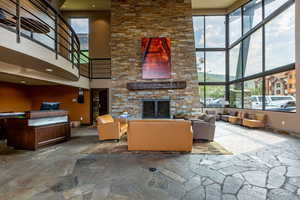 Living room featuring a high ceiling and a fireplace