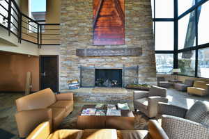 Living room with a high ceiling and a fireplace