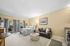 Bedroom featuring light tile patterned floors and access to exterior