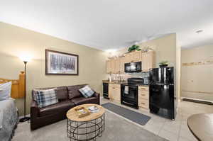 Tiled living room featuring sink