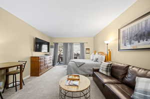 Bedroom featuring access to outside and carpet flooring