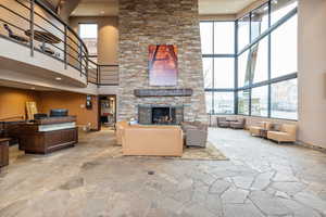 Living room featuring a fireplace and a high ceiling