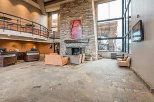 Living room with a fireplace and a high ceiling