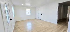 Unfurnished room with light wood-type flooring