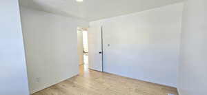 Unfurnished room featuring a textured ceiling and light hardwood / wood-style floors