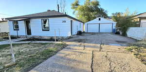 Exterior space featuring central air condition unit, an outdoor structure, and a garage