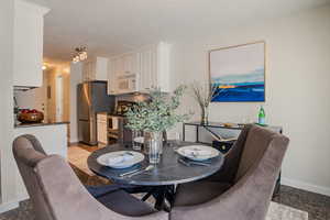 Dining space featuring light tile patterned floors